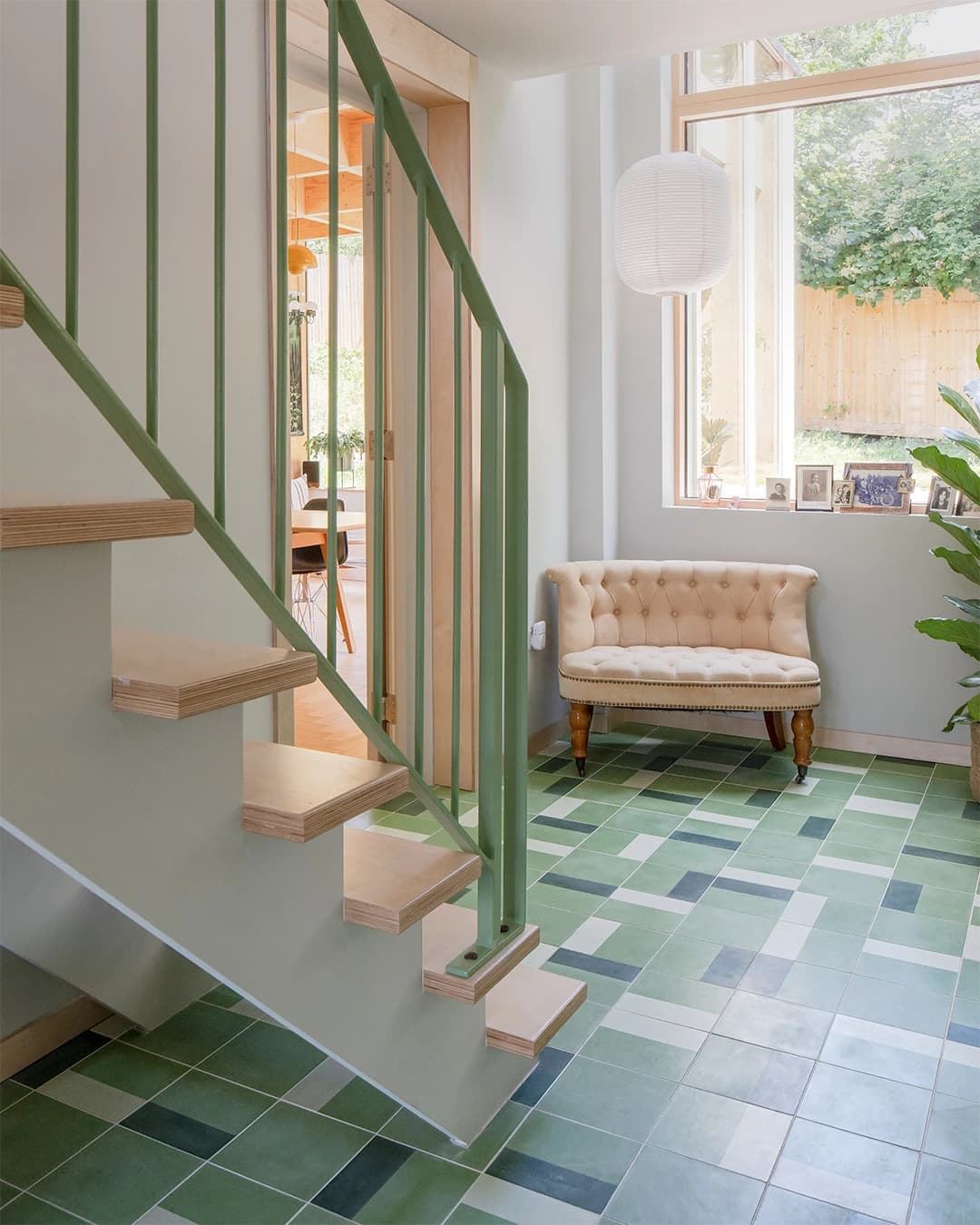 Modern green cement tiles in a stair hall.