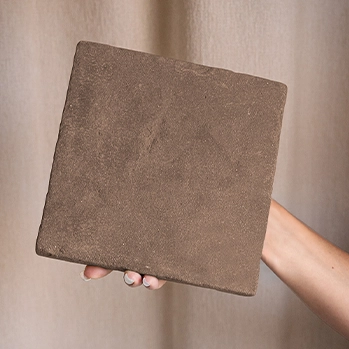 hand-holding-espresso-brown-terracotta-tile